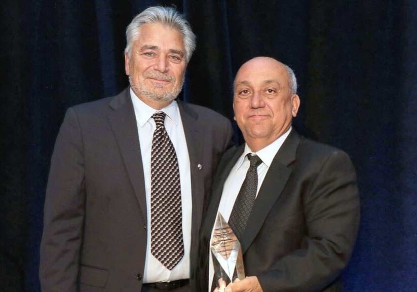 JANIS REES-KALEIDOSCOPE PHOTOGRAPHY — Sam Cutruzzola (at right) receives the Chairman’s Award of Recognition from Raymondo Mollica during the Ontario General Contractors Association’s 81st annual general meeting and conference in Muskoka, Ont.